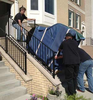 Rob, Austin and Greg safely bring a 650 pound grand piano down 11 steps.